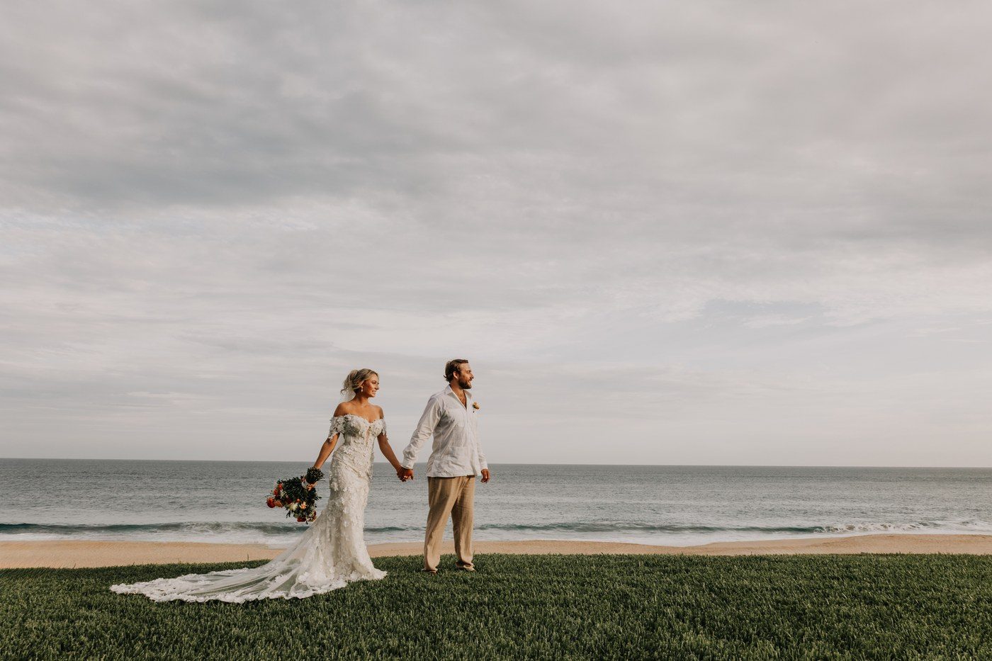 Bride and groom walking by the ocean Cabo San Lucas — Ana Badillo Photography